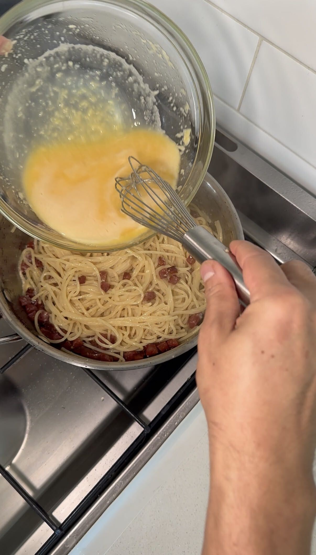 Egg yolks and pecorino whisked in a bowl